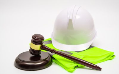 labor-related-legal-concept-with-safety-hats-work-clothes-judge-gavel-white-background_127345-264